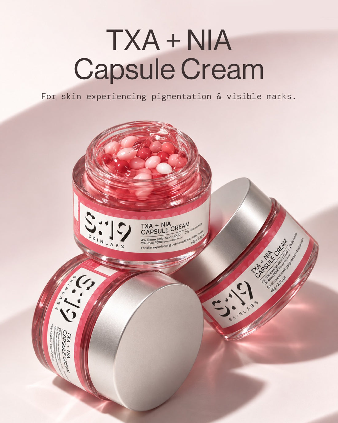 TXA + NIA Capsule Cream open jars showing pink tranexamic acid and niacinamide capsules